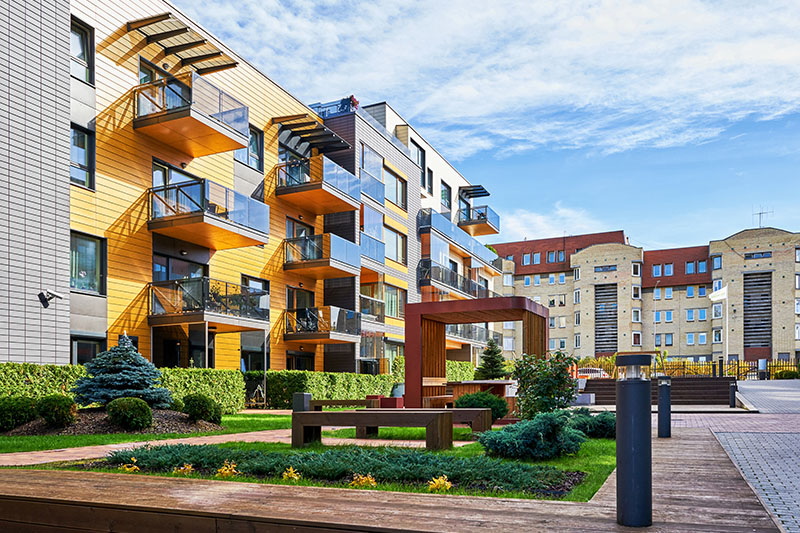 Modern complex of residential buildings with many benches